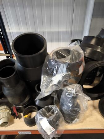 Indhold af fittings og reservedele på reol